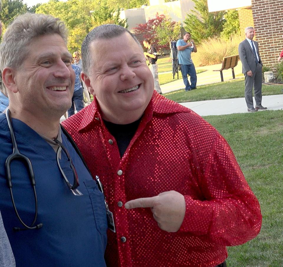 Steve Barlotta (right) takes a snapshot with Dr. Todd Cooperman after performing on the saxophone with his band Sensational Soul Cruisers outside CentraState's Star and Barry Tobias Ambulatory Campus in Freehold Township Wednesday evening, September 14, 2022. Barlotta credits Cooperman and other hospital staff for saving his life in 2020, when he was on a ventilator for 24 days and later had to relearn how to move again.
