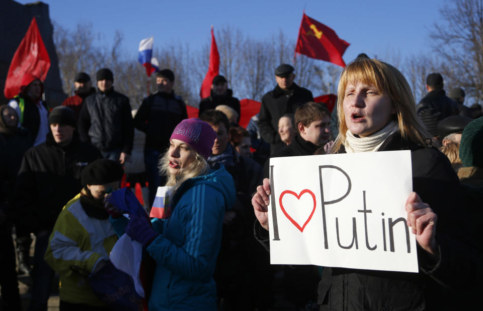 A pro Russian resident rallies with others at a central square in Donetsk, Ukraine, Friday, March 7, 2014. Russia rallied support Friday for a Crimean bid to secede from Ukraine, with Russia's top lawmaker assuring her Crimean counterpart that the region would be welcomed as "an absolutely equal subject of the Russian Federation." (AP Photo/Sergei Grits)