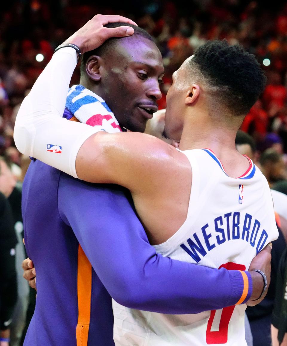 Apr 25, 2023; Phoenix, AZ, USA; Phoenix Suns center Bismack Biyombo (18) hugs LA Clippers guard Russell Westbrook (0) after the Suns won the series at Footprint Center. Mandatory Credit: Rob Schumacher-Arizona Republic