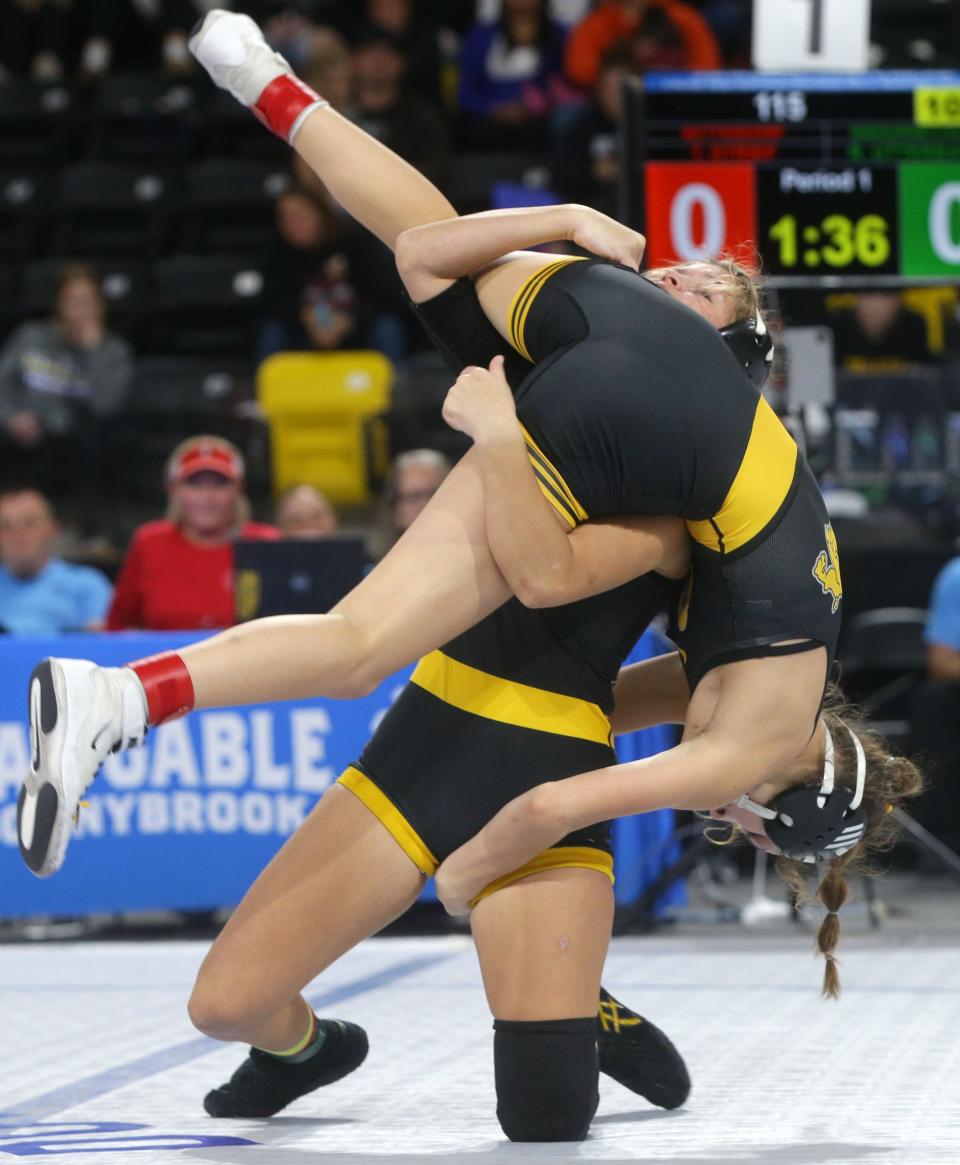 Sigourney-Keota's Reanah Utterback throws Bettendorf's Taylor Strief Friday, Dec. 1, 2023 at the Dan Gable Donnybrook wrestling tournament at Xtream Arena in Coralville, Iowa.