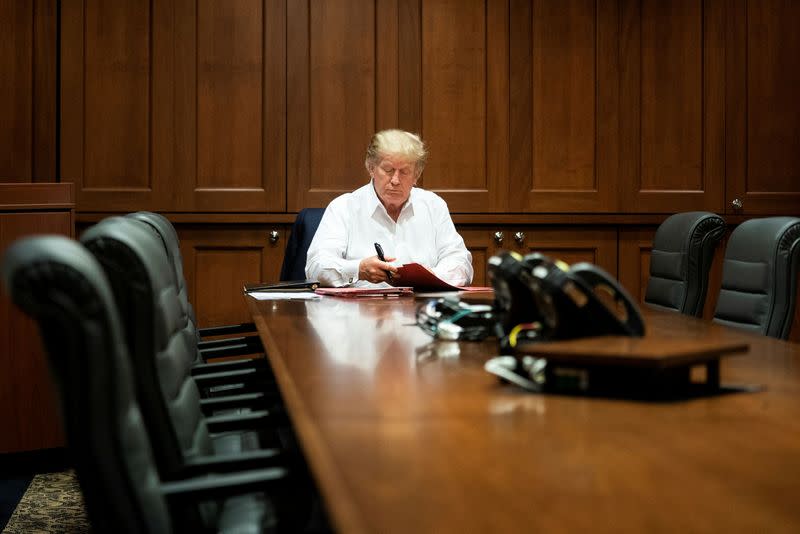 U.S. President Donald Trump works in a conference room while receiving treatment after testing positive for the coronavirus disease (COVID-19) at Walter Reed National Military Medical Center in Bethesda, Maryland