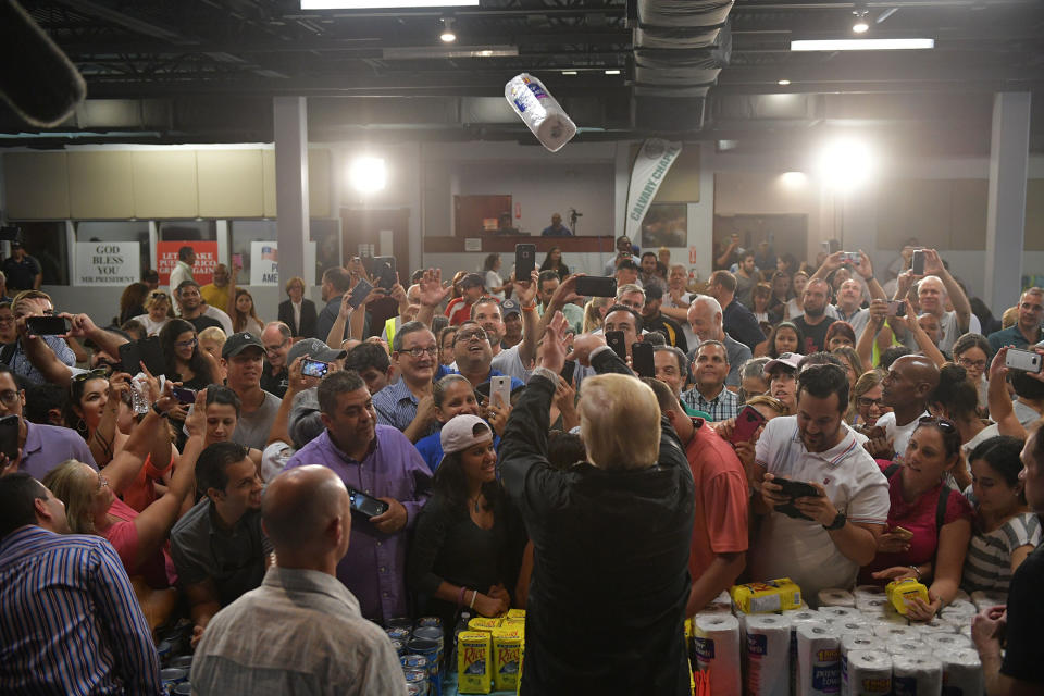 <p>OCT. 3, 2017 – President Donald Trump throws a paper towel roll as he visits the Cavalry Chapel in Guaynabo, Puerto Rico.<br> Nearly two weeks after Hurricane Maria thrashed through the US territory, much of the islands remains short of food and without access to power or drinking water. (Photo: Mandal Ngan/AFP/Getty Images) </p>