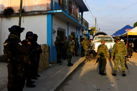 Policemen and soldiers guard a crime scene where mayoral candidate Santana Cruz Bahena was gunned down at his home in the municipality of Hidalgotitlan, in the state of Veracruz, Mexico November 20, 2017. REUTERS/Angel Hernandez