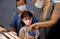 Customers wearing face masks shop at a Chinese cosmetics brand Perfect Diary store, following the coronavirus disease (COVID-19) outbreak in Beijing