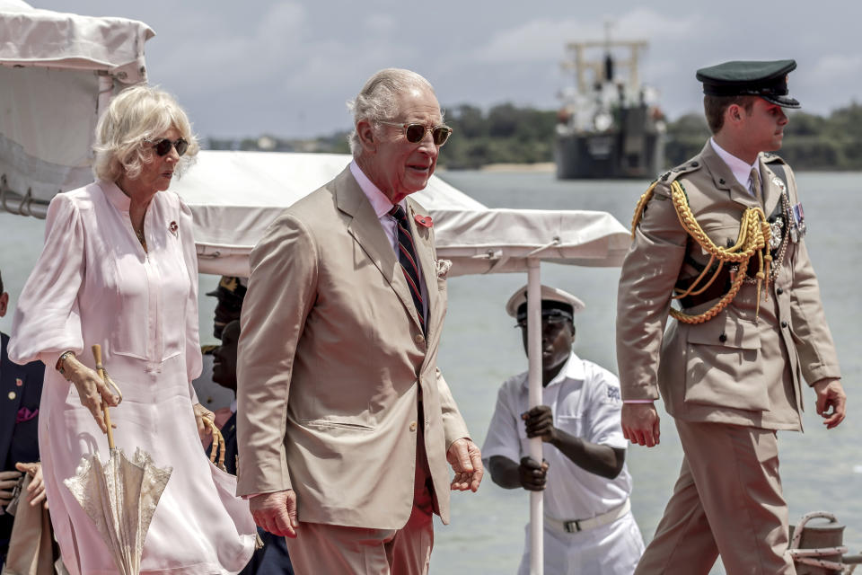 Britain's King Charles III, center, followed by Queen Camilla arrive aboard the Admiral's Barge to meet Royal Marines and Kenyan Marines at Mtongwe Naval Base, in Mombasa, Kenya, Thursday, Nov. 2, 2023. (Luis Tato/Pool Photo via AP)