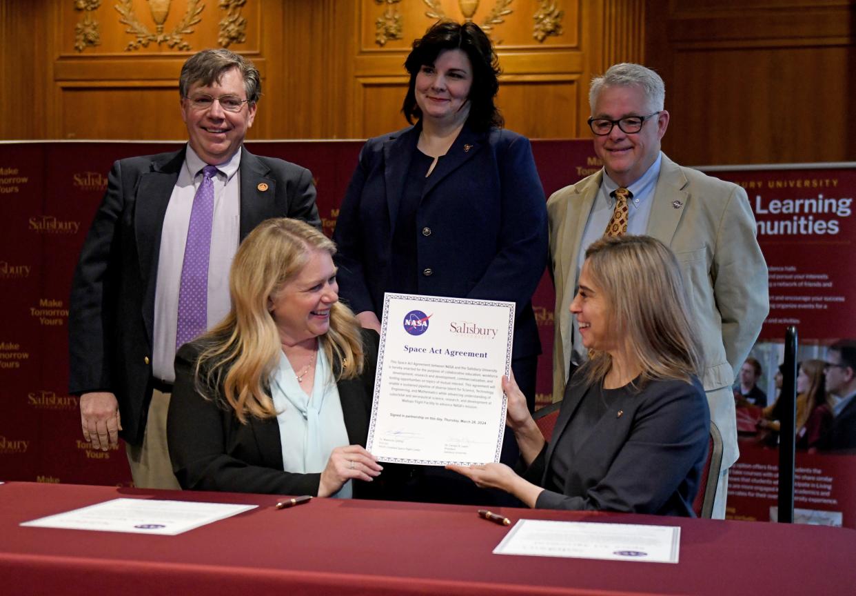 Carolyn Ringer Lepre, Salisbury University president, left, and Makenzie Lystrup, NASA's Goddard Space Flight Center director, sign the SU-NASA Space Act Agreement Thursday, March 28, 2024, in Holloway Hall's Great Hall in Salisbury, Maryland. The agreement is expected to provide learning opportunities for SU students at NASA's Wallops Flight Facility.