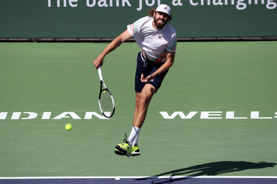Reilly Opelka of the United States serves to Rafael Nadal of Spain during the BNP Paribas Open in Indian Wells, Calif., on Wednesday, March 16, 2022. 