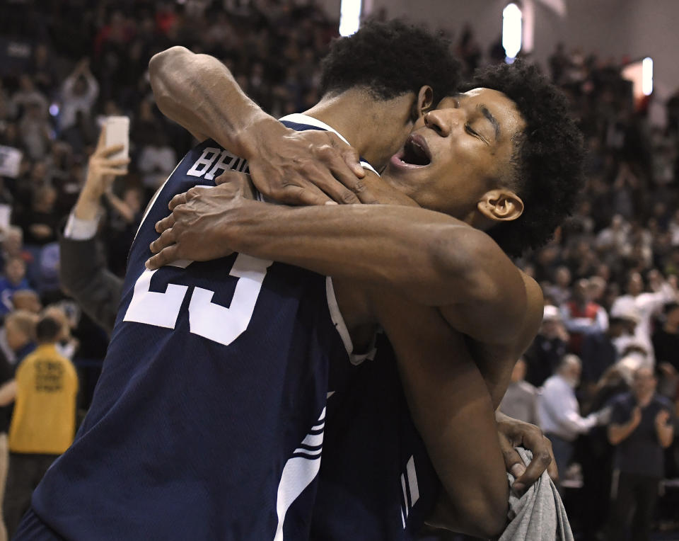 Yale's Trey Phills, right, celebrates with teammate Jordan Bruner, left, after their Ivy League championship win over Harvard in an NCAA college basketball game at Yale University in New Haven, Conn., Sunday, March 17, 2019, in New Haven, Conn. (AP Photo/Jessica Hill)