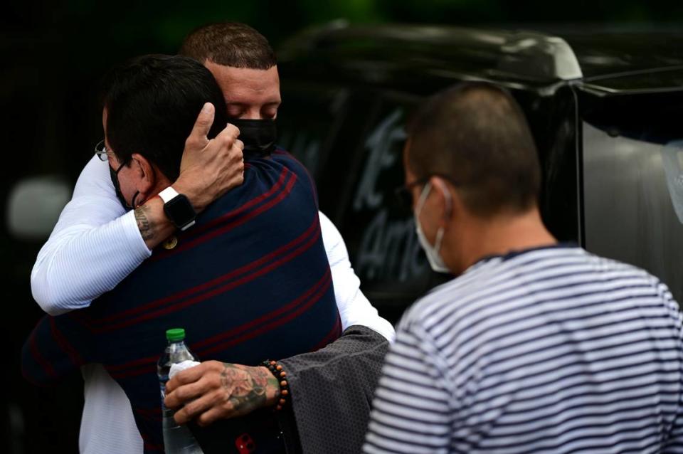 Jose Antonio Rodriguez, left, is embraced by a relative as he arrives at a wake for his 27-year-old daughter Keishla Rodriguez, at a funeral home in San Juan, Puerto Rico, Thursday, May 6, 2021.