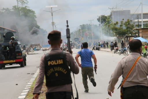 Indonesian policemen disperse protesters in Timika