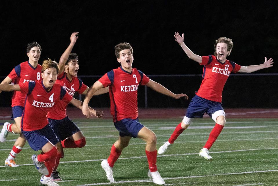 The Ketcham boys soccer team celebrates after Dominic Abbatiello's overtime goal against Arlington during an Oct. 11, 2023 match.