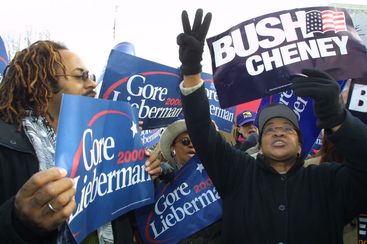 Al Gore and George Bush supporters protested outside the Supreme Court on Dec. 11, 2000, as hearings began.