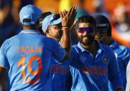 India's Ravindra Jadeja (R) celebrates with teammate Umesh Yadav after dismissing the West Indies for 182 runs during their Cricket World Cup match in Perth, March 6, 2015. REUTERS/David Gray