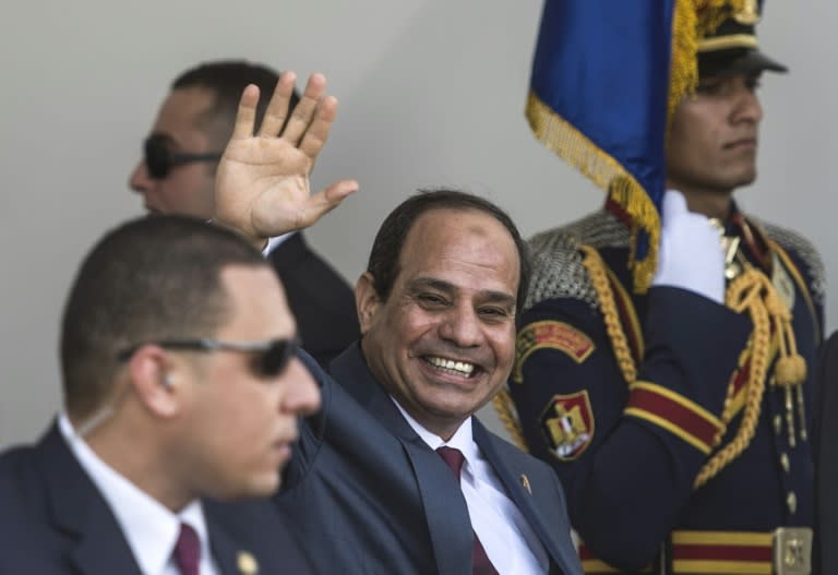 Egyptian President Abdel Fattah al-Sisi waves as he arrives for the opening ceremony of a new waterway at the Suez Canal on August 6, 2015, in the port city of Ismailiya