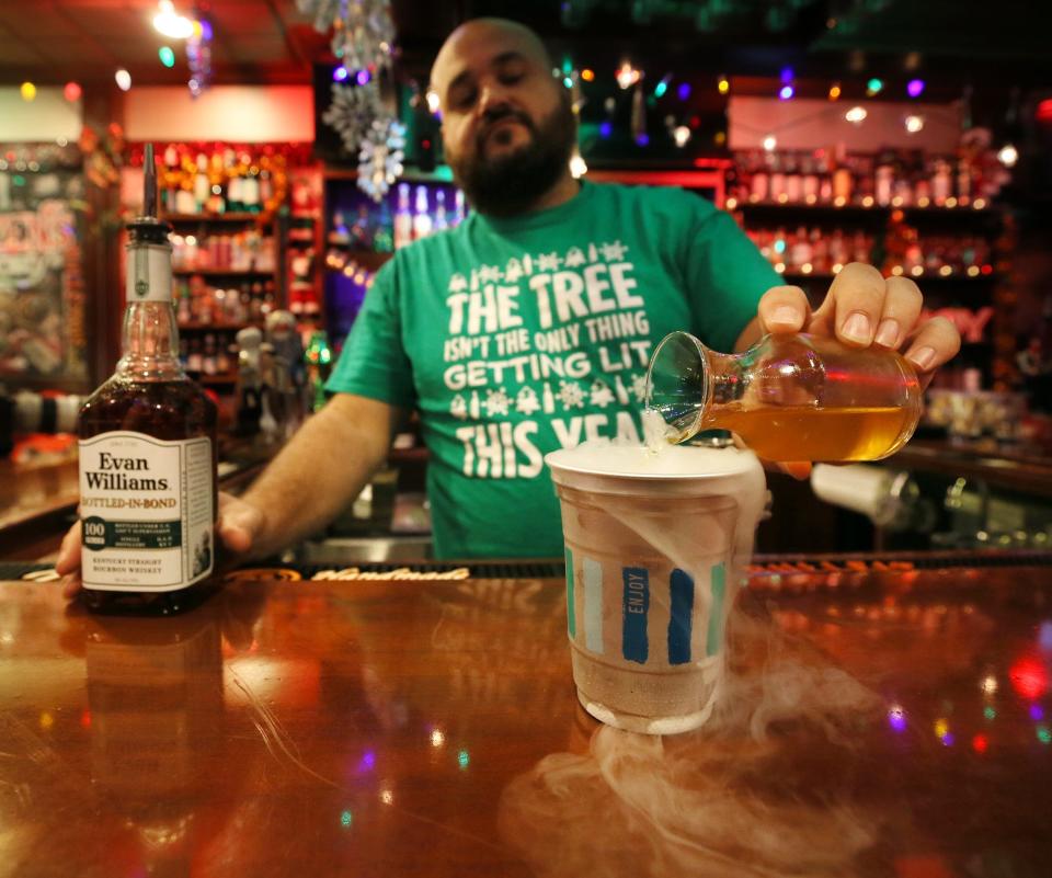 Kevin Altomare makes a "Frosted Pole Licker" with cinnamon-infused Evans Williams B.I.B. White Label Bourbon and apple cider over ice and dry ice last year at Blitzen's holiday pop-up at Hudson's Restaurant.