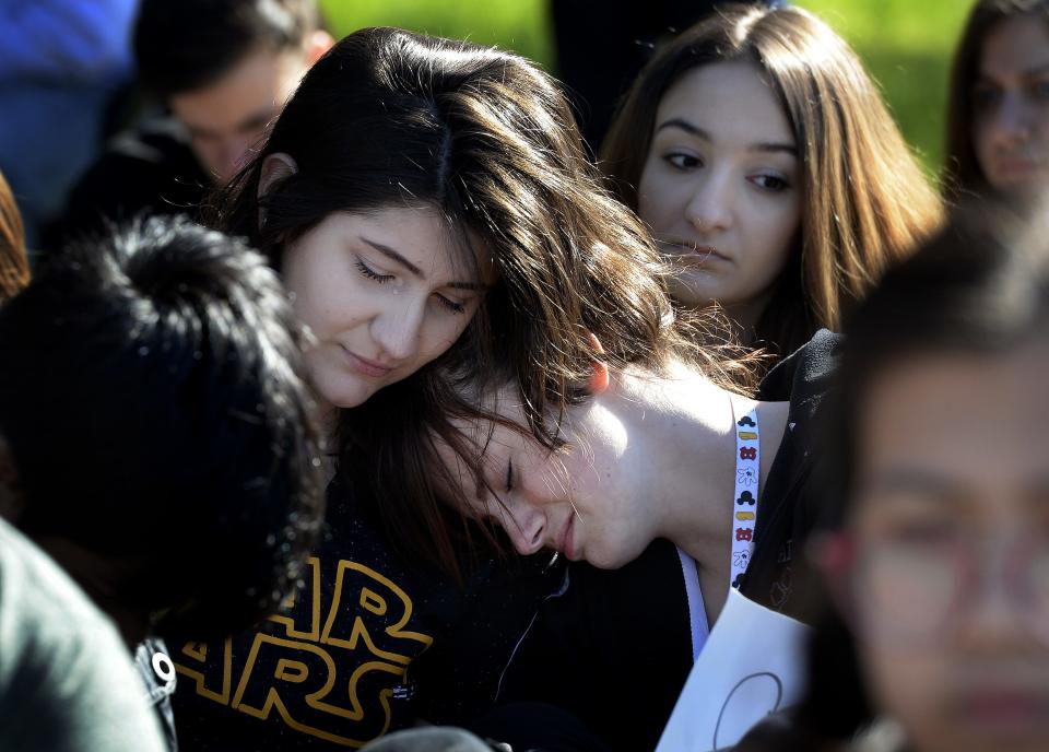 Students, Yara Ali, left, and Zoe Newcomb comfort each other, as they protest against gun violence on school campuses after walking out of class at John Overton High School on Wednesday, March 14, 2018, in Nashville Tenn. The walkout was part of a national student movement to protest for 17 minutes, one minute for each victim in the Parkland school shooting in Florida.