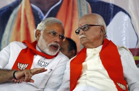 File Photo - Lal Krishna Advani (R), listens to Narendra Modi during a workers' party meeting ahead of the general election, at Gandhinagar in the western Indian state of Gujarat April 5, 2014. REUTERS/Amit Dave