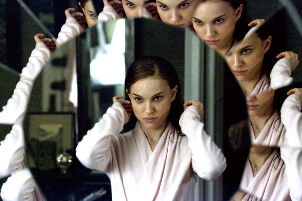 Natalie Portman looks into a mirror where you can see several different reflections of her