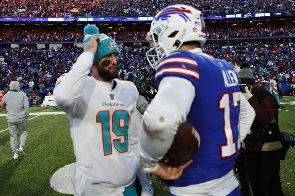 Buffalo Bills quarterback Josh Allen, right, and Miami Dolphins quarterback Skylar Thompson talk after an NFL wild-card playoff football game, Sunday, Jan. 15, 2023, in Orchard Park, N.Y. (AP Photo/Jeffrey T. Barnes)