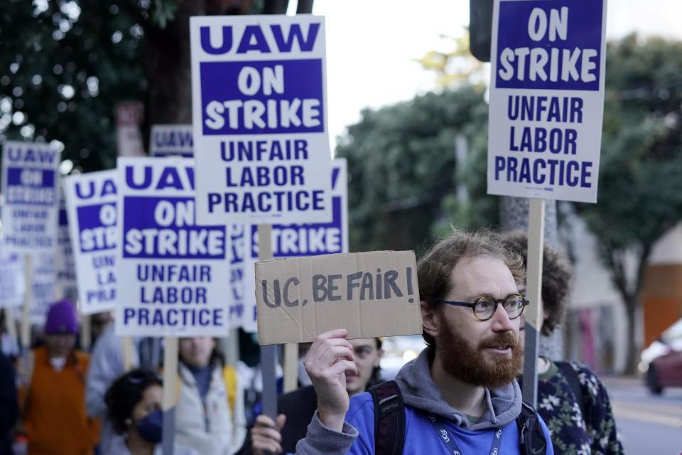 FILE - People take part in a protest outside of University of California San Francisco medical offices in San Francisco, Monday, Nov. 14, 2022. On Tuesday, Nov. 29, 2022, postdoctoral scholars and academic researchers reached a tentative labor agreement with the University of California but will remain on strike in solidarity with thousands of graduate student workers who remain on picket lines at all 10 UC campuses. (AP Photo/Jeff Chiu, File)