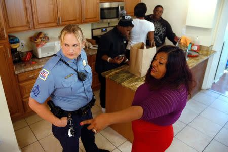 Washington Metropolitan Police Department Sergeant Jessica Hawkins (L), a transgender woman who leads the department's lesbian, gay, bisexual and transgender (LGBT) unit, speaks with transgender activist Ruby Corado at a home where Corado shelters transgender women of color in Washington, U.S. October 10, 2016. REUTERS/Jonathan Ernst