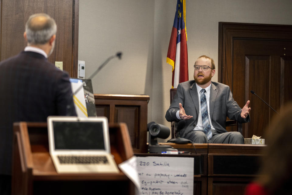Travis McMichael speaks from the witness stand during his trial Wednesday, Nov. 17, 2021, in Brunswick, Ga. McMichael, his father Greg McMichael and their neighbor, William "Roddie" Bryan, are charged with the February 2020 death of 25-year-old Ahmaud Arbery. (AP Photo/Stephen B. Morton, Pool)