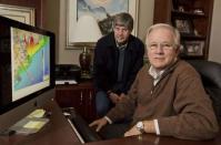 Jim Blackburn (L), professor of Environmental Law, and Philip Bedient (R), professor of Civil and Environmental Engineering at the Rice University School of Engineering; pose next to Houston-Galveston coastal map displayed on a computer screen at the school in Houston, Texas November 21, 2014. REUTERS/Richard Carson