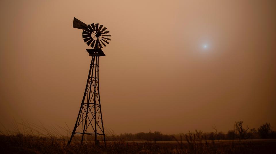 The dust from heavy winds obscures the sun in Hodgeman County in Jetmore, Kans., Wednesday, Dec. 15, 2021.