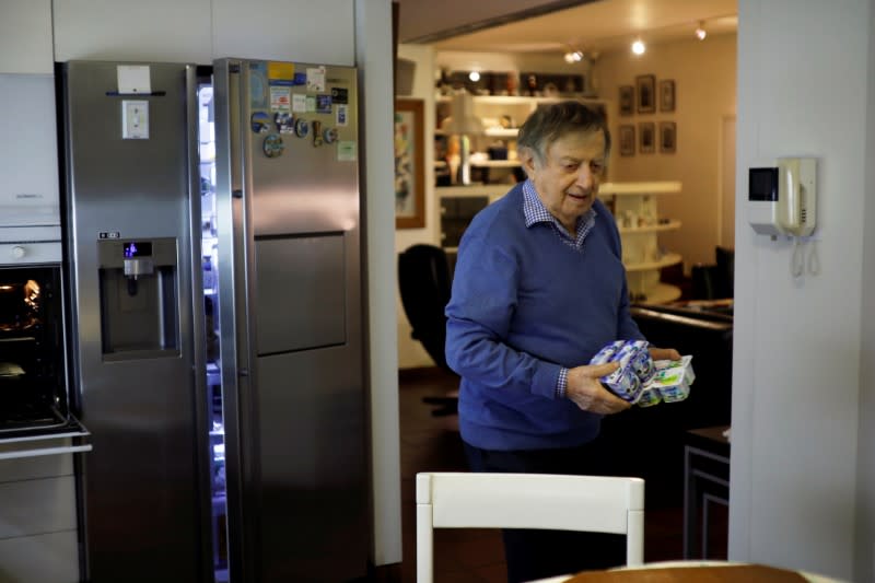 Holocaust survivor Avraham Harshalom, 95, stands in his kitchen before an interview with Reuters at his home in Ramat Gan, Israel