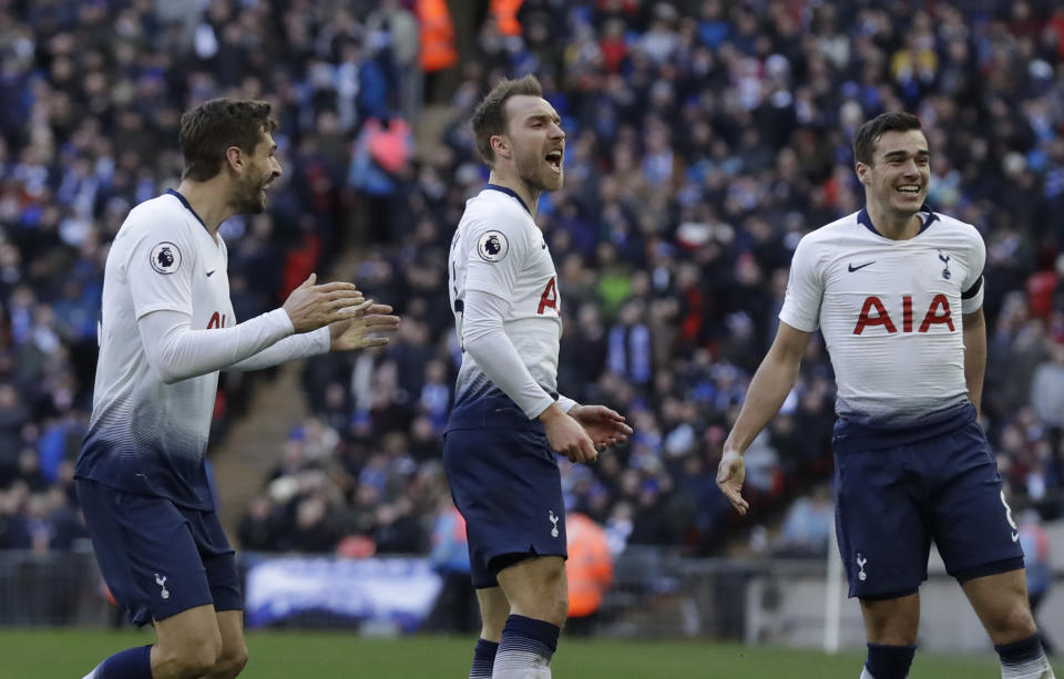 Tottenham Hotspur's Christian Eriksen, center, celebrates with Tottenham Hotspur's Harry Winks, right, after scoring his side's second goal during the English Premier League soccer match between Tottenham Hotspur and Leicester City at Wembley stadium in London, Sunday, Feb. 10, 2019. (AP Photo/Matt Dunham)