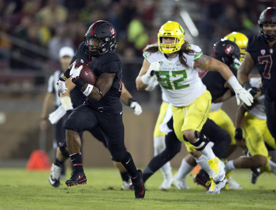 In this Oct. 14, 2017, file photo, Stanford’s Bryce Love, left, breaks free for a long touchdown against Oregon during the first quarter of an NCAA college football game in Stanford, Calif. Love tweaked an ankle against Oregon and is a game-time decision for their game Thursday, Oct. 26, 2017, against Oregon State in Corvallis, Ore . (AP Photo/D. Ross Cameron, File)