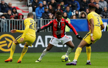 Soccer Football - Ligue 1 - OGC Nice vs Paris St Germain - Allianz Riviera, Nice, France - March 18, 2018 Nice's Allan Saint-Maximin in action with Paris Saint-Germain’s Layvin Kurzawa and Presnel Kimpembe REUTERS/Jean-Paul Pelissier