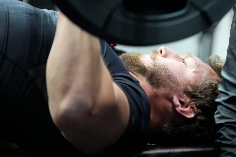 Cole Strange performs the bench press drill during the NFL Combine in Indianapolis on March 3.