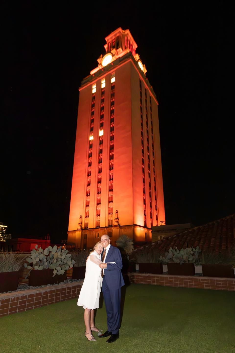 Rozanne and Billy Rosenthal stand in front of the UT Tower, which was lit orange in their honor Jan. 16. The couple donated $25 million to the McCombs School of Business.
