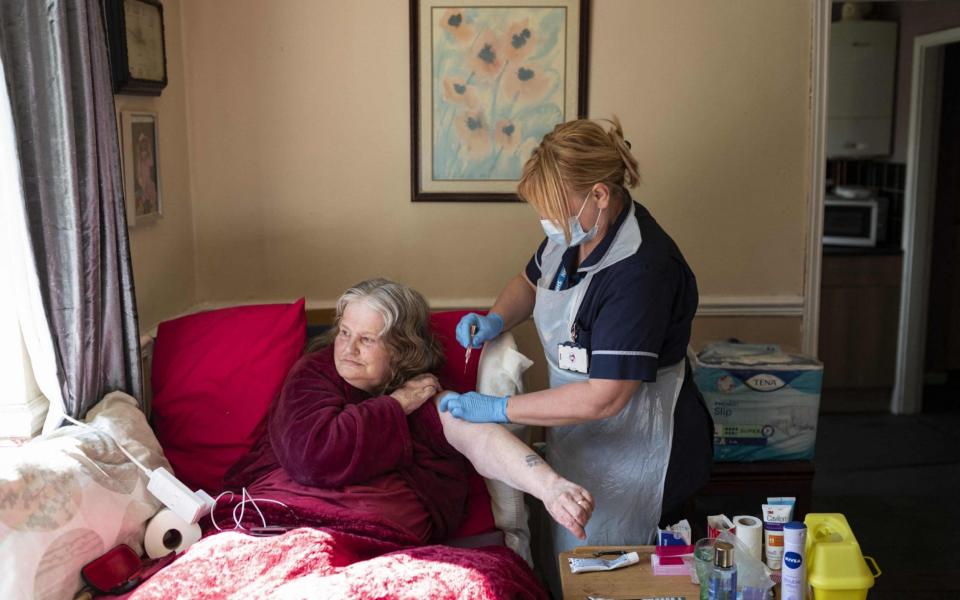 A housebound patient receives her vaccine in Chesterfield, Derbyshire - Oli Scarff/AFP