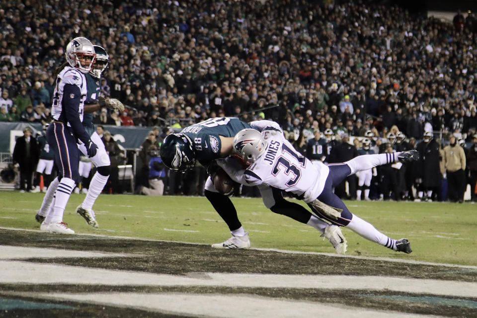 Philadelphia Eagles' Dallas Goedert (88) scores a touchdown against New England Patriots' Jonathan Jones (31) during the first half of an NFL football game, Sunday, Nov. 17, 2019, in Philadelphia. (AP Photo/Matt Rourke)