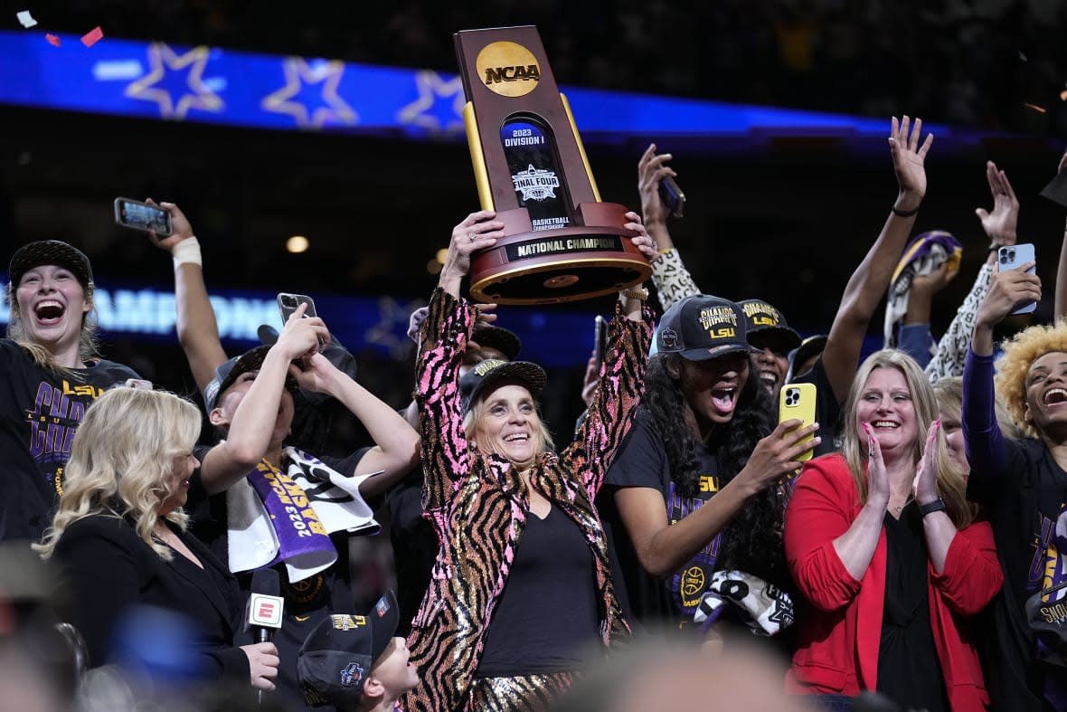 LSU head coach Kim Mulkey holds the winning trophy after the NCAA Women’s Final Four championship basketball game against Iowa Sunday, April 2, 2023, in Dallas. LSU won 102-85 to win the championship. (AP Photo/Tony Gutierrez)