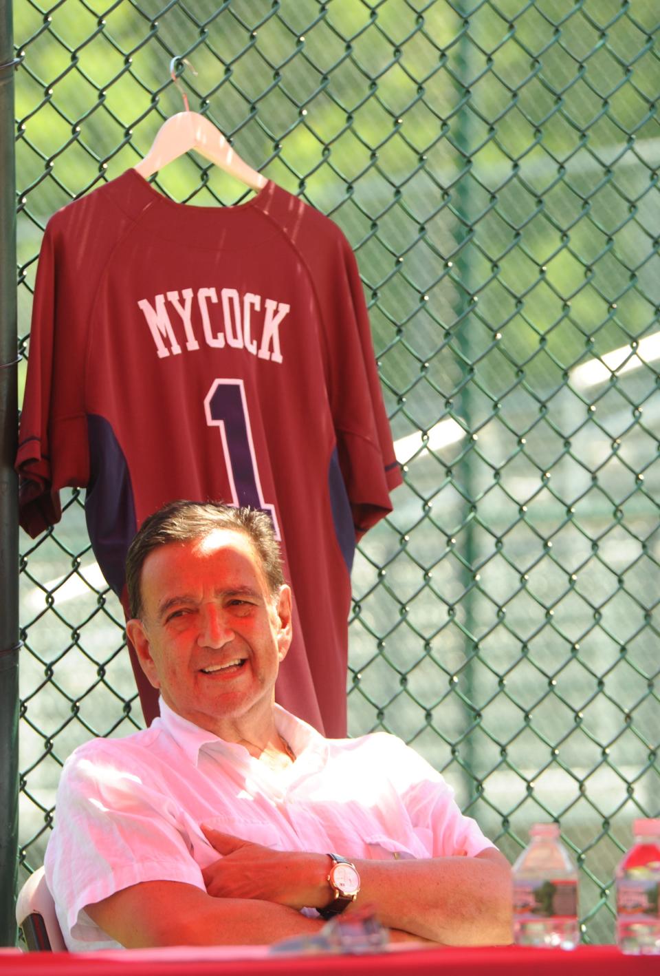 In 2016, William "Bill" Richardson, the former governor of New Mexico and 1967 Cotuit Kettleers pitcher, sits under a jersey with Arnold Mycock's name on it. Richardson attended the celebration of the life and legacy of Arnold Mycock at Lowell Park.