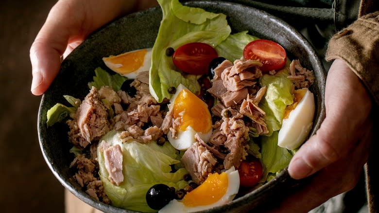 Holding a bowl of salade niçoise