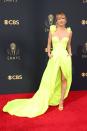 <p>Neon was a big trend for the night, and Kaley Cuoco was on board. The actress chose a chic gown by Vera Wang, which featured floral detail on the strappy shoulders and a slit. She paired the look with matching shoes and a messy updo.</p>