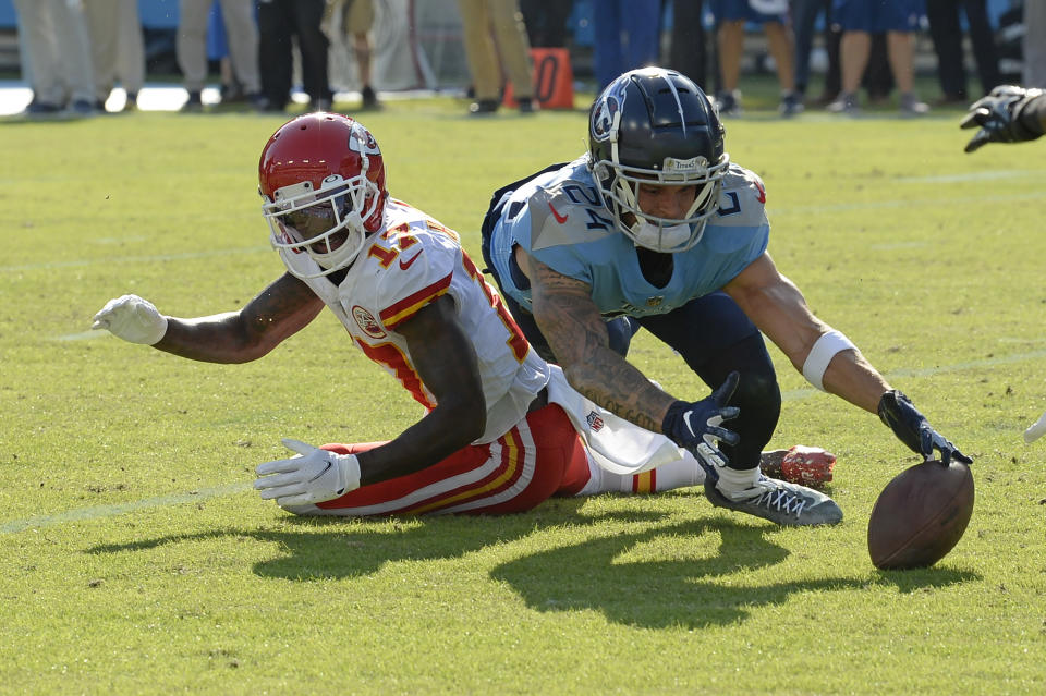 Kansas City Chiefs wide receiver Mecole Hardman (17) fumbles the ball as Tennessee Titans cornerback Elijah Molden (24) dives for it in the second half of an NFL football game Sunday, Oct. 24, 2021, in Nashville, Tenn. The Titans recovered the ball on the play. (AP Photo/Mark Zaleski)