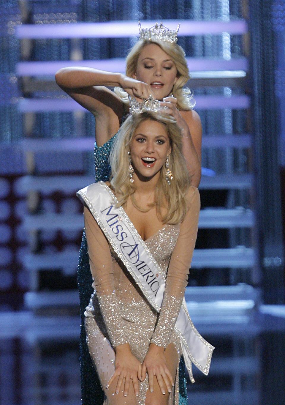 FILE - In this Jan. 26, 2008 file photo, Kirsten Haglund is crowned Miss America 2008 by former Miss America Lauren Nelson during the Miss America Pageant at the Planet Hollywood hotel and casino in Las Vegas. (AP Photo/Jae C. Hong)