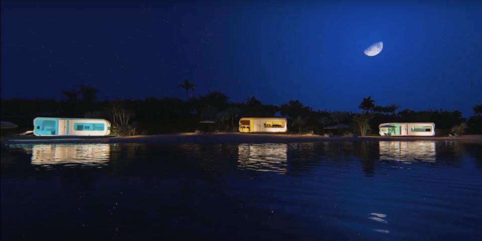 a rendering of 3 Cube Two X tiny homes on a beach at night