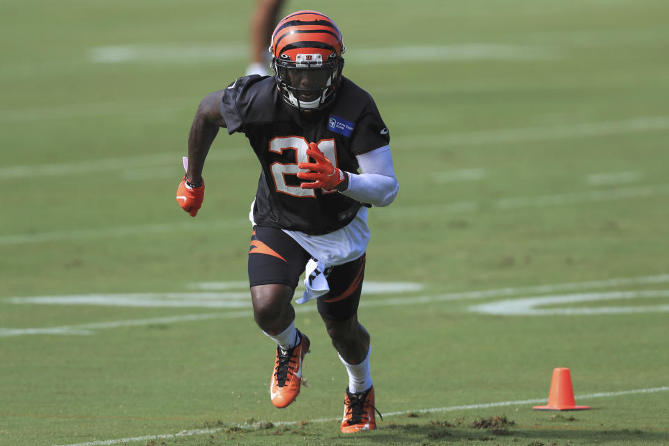 FILE - In this Monday, Aug. 17, 2020, file photo, Cincinnati Bengals' Mackensie Alexander (21) runs a drill during an NFL football camp practice in Cincinnati. Mackensie Alexander was jailed Wednesday, Aug. 26, 2020, charged with misdemeanor battery, after deputies say he beat up a man shortly after Alexander returned to Florida to help search for his missing father.  Alexander, 26, and another man, 28-year-old Evins Clement, were arrested by Collier County sheriff's deputies Tuesday nightn (AP Photo/Aaron Doster, File)