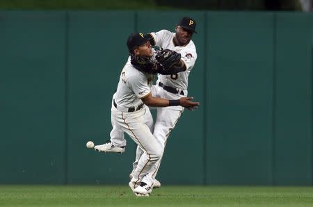 Apr 19, 2019; Pittsburgh, PA, USA; Pittsburgh Pirates shortstop Erik Gonzalez (left) and center fielder Starling Marte (right) collide while chasing a fl yball against the San Francisco Giants during the eighth inning at PNC Park. Both players would leave the game. Mandatory Credit: Charles LeClaire-USA TODAY Sports