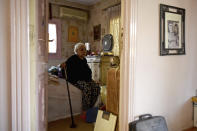 Ikhlas Helmy, an 88-year-old owner of a houseboat in Cairo, Egypt, sits in her bedroom on June 27, 2022. A government push to remove the string of houseboats from Cairo’s Nile banks has dwindled their numbers from a several dozen to just a handful. Helmy stands to evicted, and the boat moved or demolished. The tradition of living on the Nile River dates back to the 1800s, and the removal of the boats has drawn criticism in Egypt. The government says it plans to develop the waterfront. (AP Photo/Tarek Wagih)