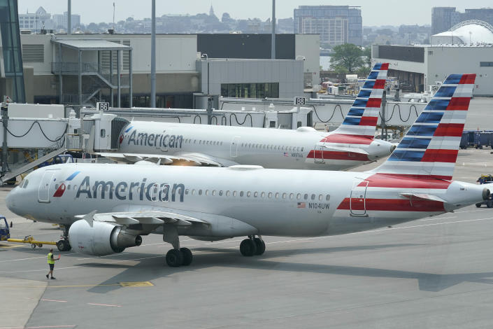 FILE - American Airlines passenger jets prepare for departure, Wednesday, July 21, 2021, near a terminal at Boston Logan International Airport, in Boston. (AP Photo/Steven Senne, File)