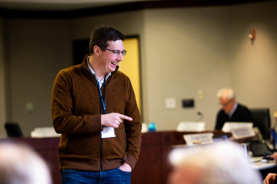 Commissioner Joe Moss points and smiles as he takes his seat during the board's meeting Tuesday, March 14, 2023, in West Olive. 