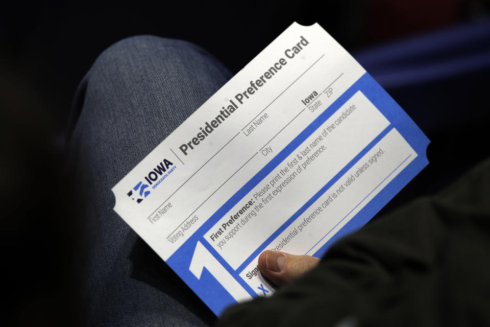 FILE - A Precinct 68 Iowa Caucus voter holds a presidential preference card as the night of caucusing gets underway at the Knapp Center on the Drake University campus in Des Moines, Iowa, Feb. 3, 2020. Iowa Democrats are proposing two key changes that they hope will increase participation and avoid the chaos that marred their 2020 caucuses. One change would allow Iowa Democrats to submit presidential preference cards by mail or in person before caucus night. (AP Photo/Gene J. Puskar, File)