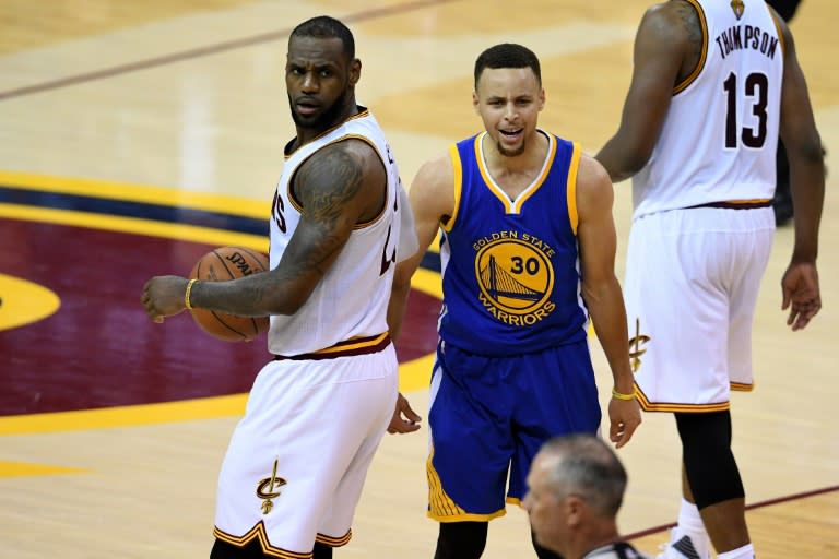Stephen Curry (R) of the Golden State Warriors reacts to a foul call during the fourth quarter as LeBron James of the Cleveland Cavaliers looks on in Game 6 of the 2016 NBA Finals, at Quicken Loans Arena in Cleveland, Ohio, on June 16